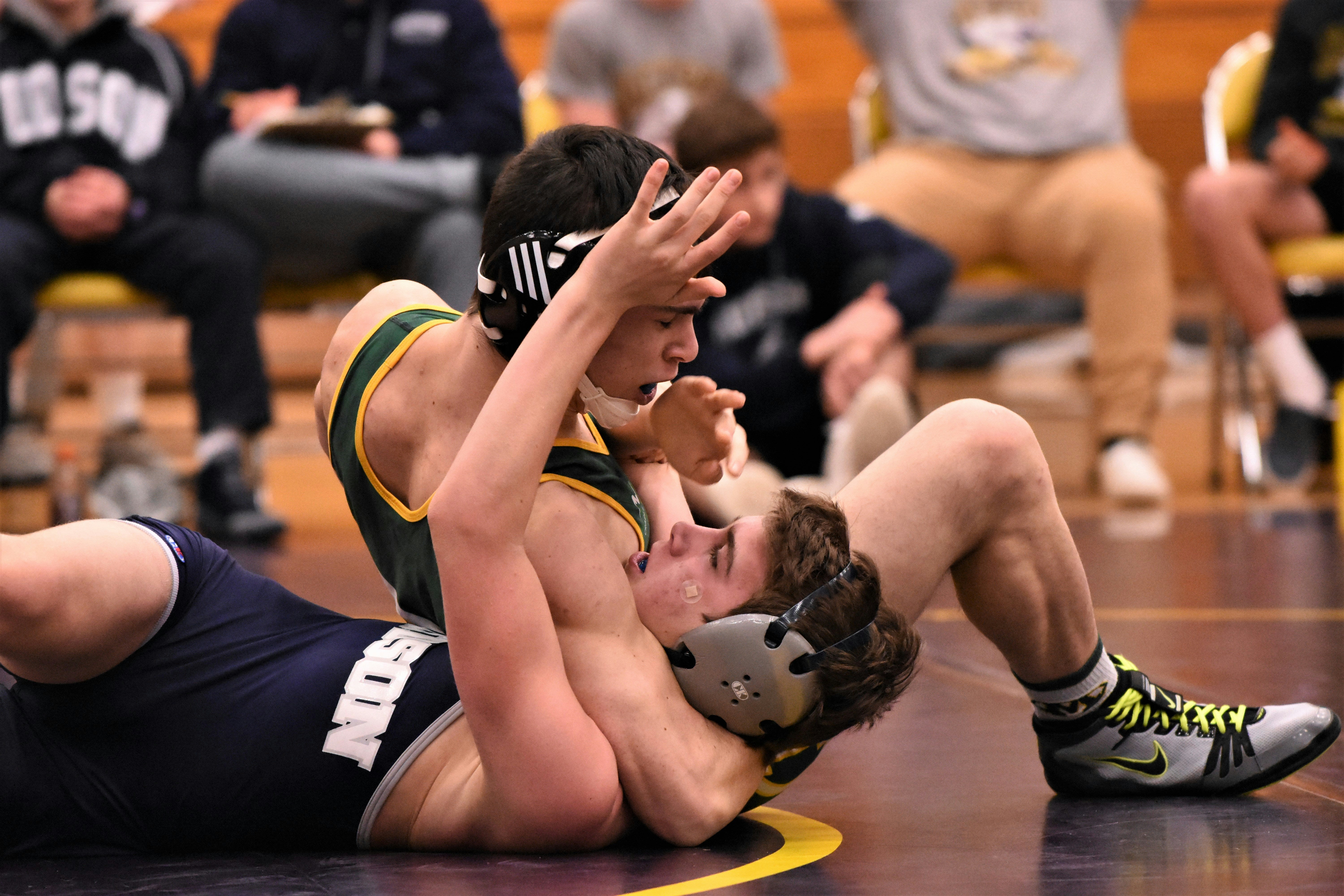 Two male wrestlers competing with mental toughness and focus under pressure Mack Mental Performance mental performance coaching